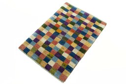 Corner detail of 2000s Persian Gabbeh rug showing border pattern and Wool pile