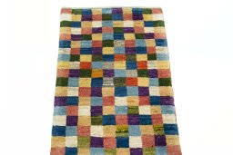 Surface texture of 2000s Persian Gabbeh rug with natural Wool and intricate pattern