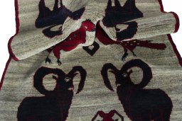 Corner detail of 2000s Persian Gabbeh rug showing border pattern and Wool pile