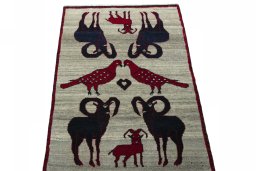 Surface texture of 2000s Persian Gabbeh rug with natural Wool and intricate pattern