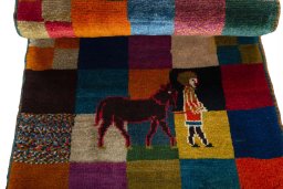 Corner detail of 2000s Persian Gabbeh rug showing border pattern and Wool pile