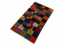 Corner detail of 2000s Persian Gabbeh rug showing border pattern and Wool pile