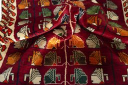 Corner detail of 2000s Persian Gabbeh rug showing border pattern and Wool pile