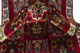 Corner detail of 2000s Persian Gabbeh rug showing border pattern and Wool pile
