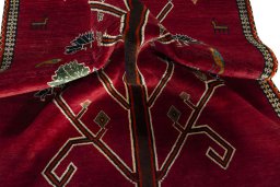 Corner detail of 2000s Persian Gabbeh rug showing border pattern and Wool pile