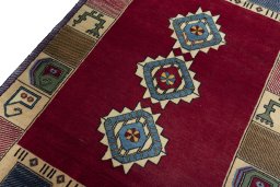Backside of handmade 2000s Persian Gabbeh rug showing knot structure and weave density