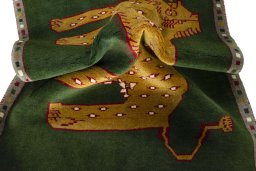 Corner detail of 2000s Persian Gabbeh rug showing border pattern and Wool pile