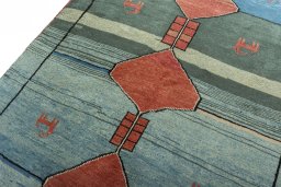 Backside of handmade 2000s Persian Gabbeh rug showing knot structure and weave density