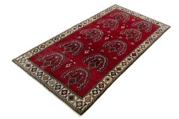 Corner detail of 2000s Persian Gabbeh rug showing border pattern and Wool pile