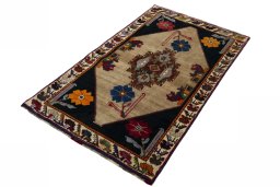 Corner detail of 2000s Persian Gabbeh rug showing border pattern and Wool pile