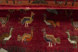 Corner detail of 2000s Persian Gabbeh rug showing border pattern and Wool pile