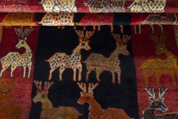 Full view of 2000s Persian Gabbeh rug from Iran / Persia, 231 × 129 cm in Red tones