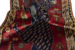 Corner detail of 2000s Persian Gabbeh rug showing border pattern and Wool pile