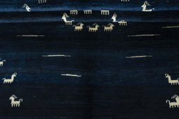 Corner detail of 2000s Persian Gabbeh rug showing border pattern and Wool pile