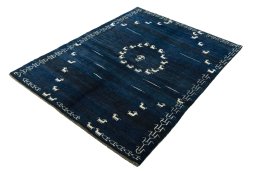 Corner detail of 2000s Persian Gabbeh rug showing border pattern and Wool pile