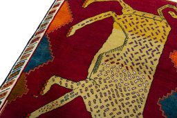 Backside of handmade 2000s Persian Gabbeh rug showing knot structure and weave density