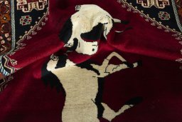 Corner detail of 2000s Persian Gabbeh rug showing border pattern and Wool pile
