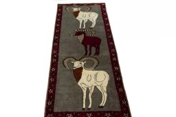 Surface texture of 2000s Persian Gabbeh rug with natural Wool and intricate pattern