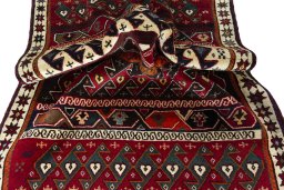 Corner detail of 2000s Persian Gabbeh rug showing border pattern and Wool pile
