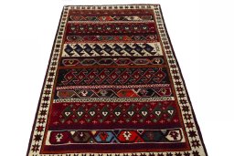 Surface texture of 2000s Persian Gabbeh rug with natural Wool and intricate pattern