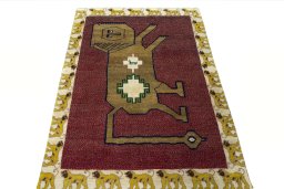 Surface texture of 2000s Persian Gabbeh rug with natural Wool and intricate pattern