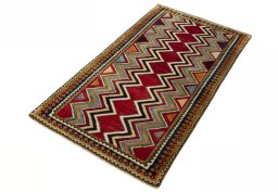 Corner detail of 2000s Persian Gabbeh rug showing border pattern and Wool pile