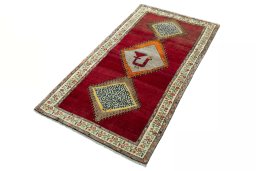 Corner detail of 2000s Persian Gabbeh rug showing border pattern and Wool pile