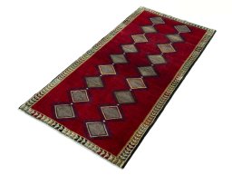 Corner detail of 2000s Persian Gabbeh rug showing border pattern and Wool pile