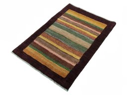Corner detail of 2000s Persian Gabbeh rug showing border pattern and Wool pile