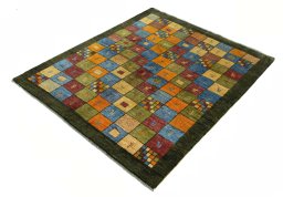 Corner detail of 2000s Persian Gabbeh rug showing border pattern and Wool pile