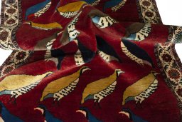 Corner detail of 2000s Persian Gabbeh rug showing border pattern and Wool pile