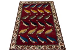 Surface texture of 2000s Persian Gabbeh rug with natural Wool and intricate pattern