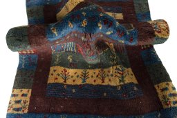 Corner detail of 2000s Persian Gabbeh rug showing border pattern and Wool pile