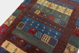 Backside of handmade 2000s Persian Gabbeh rug showing knot structure and weave density