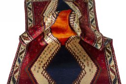 Corner detail of 2000s Persian Gabbeh rug showing border pattern and Wool pile