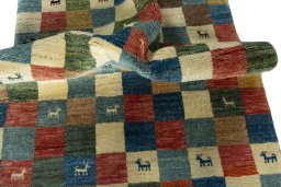 Corner detail of 2000s Persian Gabbeh rug showing border pattern and Wool pile