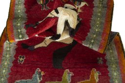 Corner detail of 2000s Persian Gabbeh rug showing border pattern and Wool pile