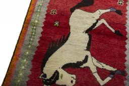 Backside of handmade 2000s Persian Gabbeh rug showing knot structure and weave density