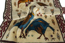 Corner detail of 2000s Persian Gabbeh rug showing border pattern and Wool pile