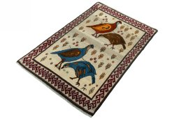 Corner detail of 2000s Persian Gabbeh rug showing border pattern and Wool pile