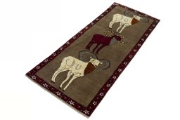 Corner detail of 2000s Persian Gabbeh rug showing border pattern and Wool pile