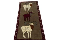 Surface texture of 2000s Persian Gabbeh rug with natural Wool and intricate pattern