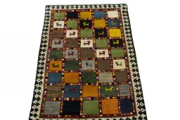 Surface texture of 2000s Persian Gabbeh rug with natural Wool and intricate pattern
