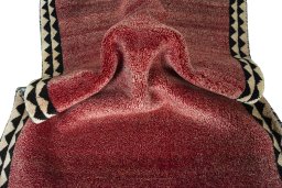 Corner detail of 2000s Persian Gabbeh rug showing border pattern and Wool pile