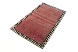 Corner detail of 2000s Persian Gabbeh rug showing border pattern and Wool pile