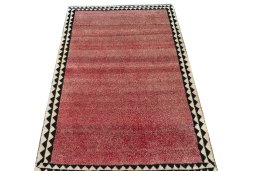 Surface texture of 2000s Persian Gabbeh rug with natural Wool and intricate pattern