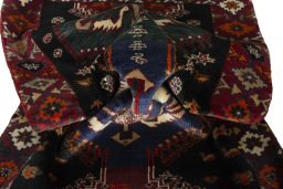 Corner detail of 2000s Persian Gabbeh rug showing border pattern and Wool pile