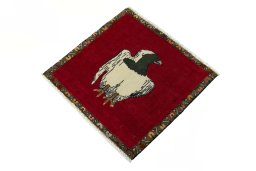 Corner detail of 2000s Persian Gabbeh rug showing border pattern and Wool pile