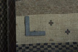 Surface texture of 2000s Persian Gabbeh rug with natural Wool and intricate pattern