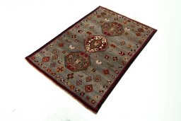 Corner detail of 2000s Persian Gabbeh rug showing border pattern and Wool pile